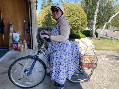 Kelsey on a bike loaded with food from the farmer's market