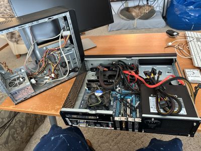 Desktop computers in partial assembly spread out on a table